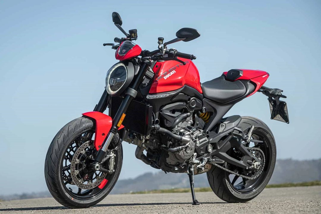 Femme se tenant sur une moto Ducati Monster