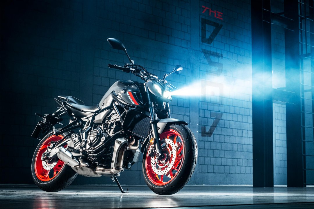 Moto roadster Yamaha MT-07 2021 de couleur noire et orange garée dans la nuit