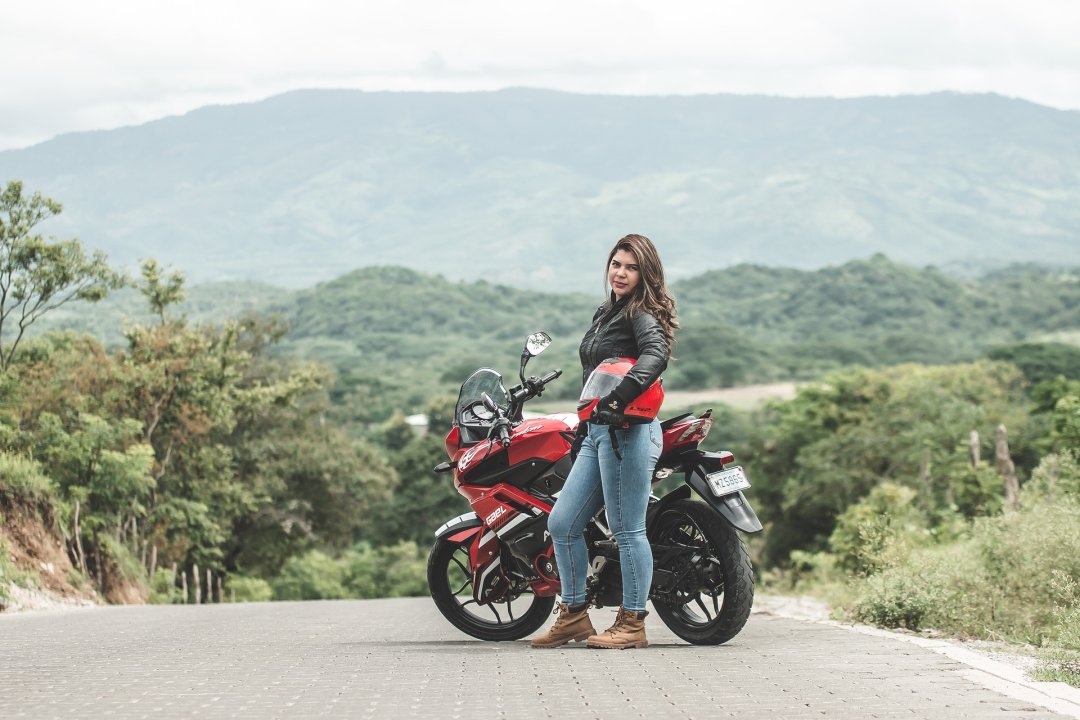 Women wearing motorcycle jacket, jeans and ankle boots