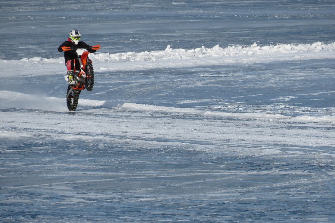 Motorcyclist riding his motorbike on ice