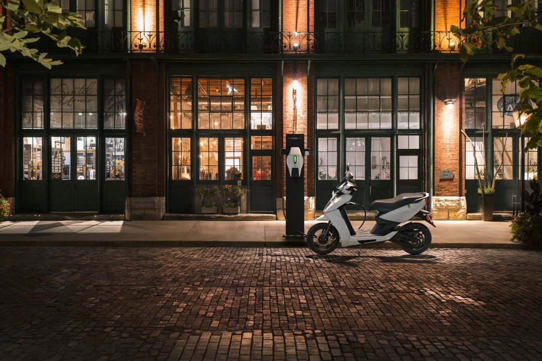 Scooter électrique de couleur blanche garé dans une rue de nuit